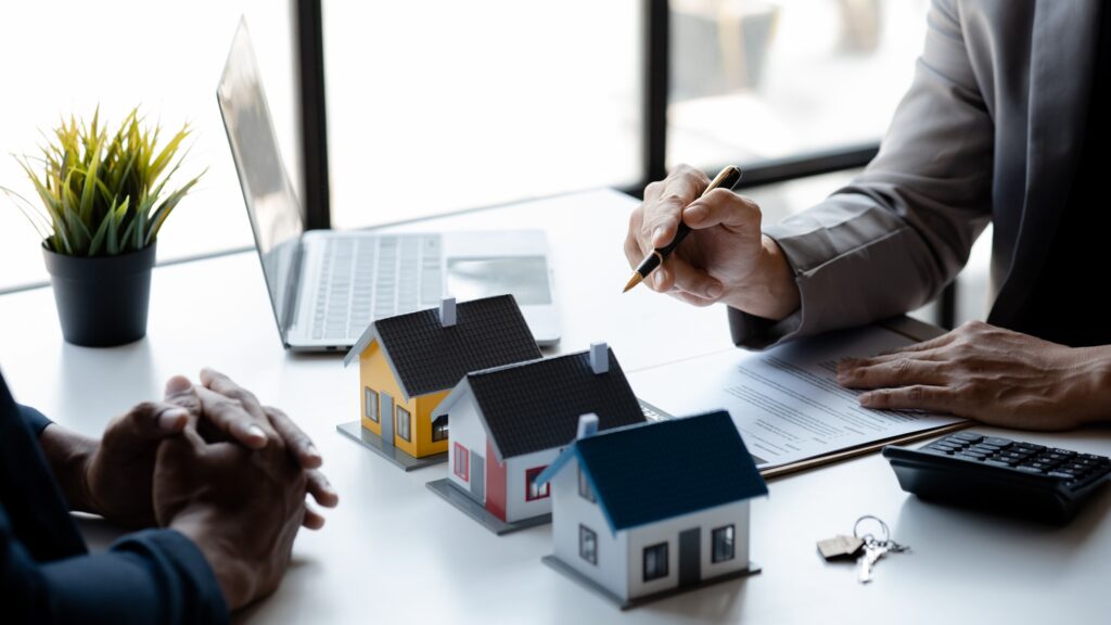 Real estate agents explain models of housing estates in projects.